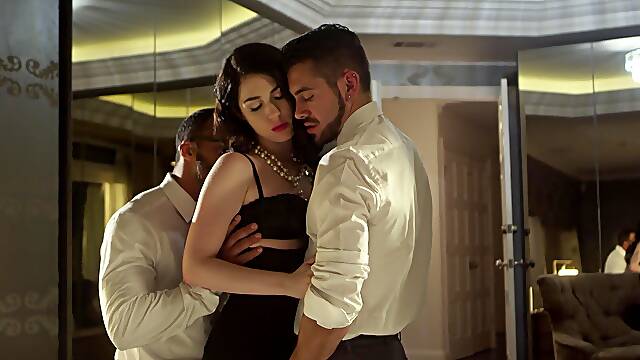 Two guys share a hot brunette's pussy in an intense threesome scene.