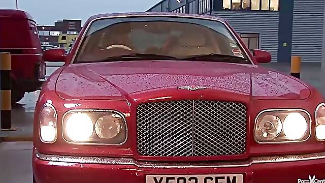Two crazy bitches are sucking a massive cock, while on the back seat, of the car